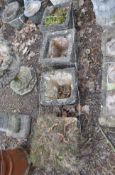 A SELECTION OF FOUR SQUARE CONCRETE PLANTERS, all with brickwork detail to sides, the largest