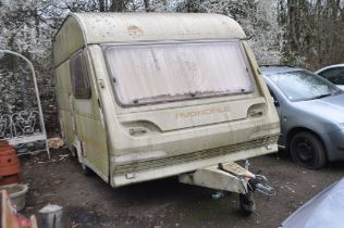 AN AVONDALE 4 BERTH CARAVAN with two bench seats, kitchen, shower room, total length from hitch to