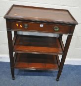 AN EDWARDIAN MAHOGANY THREE TIER SERVING TABLE, each tier with a dished top, a single frieze drawer,