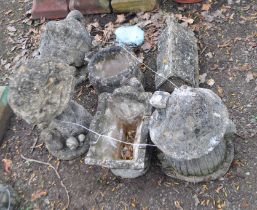 A COLLECTION OF SIX NOVELTY CONCRETE GARDEN ORNAMENTS, including a watering can, a cottage tea