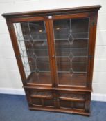 OLD CHARM, A 20TH CENTURY OAK LEAD GLAZED DISPLAY CABINET, with double glass doors, over double
