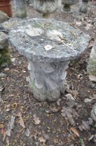 A MODERN CONCRETE GARDEN SEAT, in the form of a tree stump with a ringed round plank for a top,
