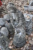 A CONCRETE GARDEN FIGURE ON STAND, in the form if a lady holding a bird figure, height 85cm, stand