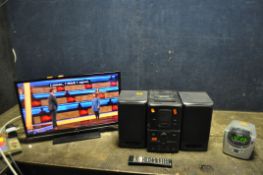 A JVC 24in LED SMART TV WITH REMOTE (stand not attached), a Daewoo mini hi fi Tape not playing)