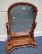 A 19TH CENTURY MAHOGANY DRESSING MIRROR, with an arched top, scrolled supports, raised on a