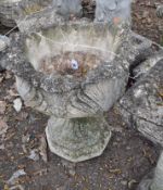 A MODERN CONCRETE GARDEN URN, constructed in two pieces with acanthus leaf detail to bowl