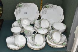 A FORTY PIECE SHELLEY TEA SET, pattern no 0234 printed and tinted with green flowers, shapes vary,
