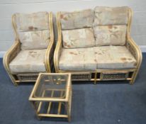 A THREE PIECE RATTAN CONSERVATORY SUITE, comprising a two seater sofa, length 120cm x depth 91cm x