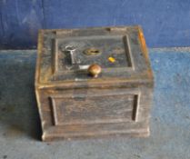 A VINTAGE CAST IRON SAFE with key and loose brass handle, width 41cm, depth 34cm, height 31cm