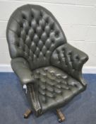 A GREEN LEATHER SWIVEL OFFICE CHAIR, with buttoned upholstery, an arched back, width 76cm x height