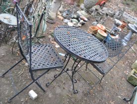 A MODERN ROUND METAL GARDEN TABLE, with latticework, 70cm diameter top, and a pair of matching