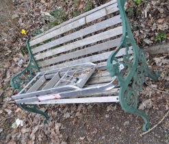 A LATE 20th CENTURY GARDEN BENCH, with cast iron ends, lion mask motifs, wooden slatted seat and