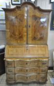 A 19TH CENTURY DUTCH WALNUT BUREAU BOOKCASE, with an arched top, the double doors enclosing nine