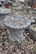 A MODERN CONCRETE GARDEN SEAT, in the form of a tree stump with a ringed round plank for a top,