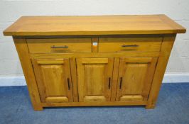 A MODERN OAK SIDEBOARD, fitted with two drawers, over three cupboard doors, length 140cm x depth