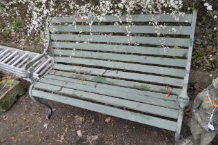 A LATE 20th CENTURY GARDEN BENCH, with cast iron ends, lion mask motifs and wooden slatted seat