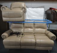 A CREAM LEATHER TWO PIECE ELECTRIC RECLINING LOUNGE SUITE, comprising a three seater sofa, length