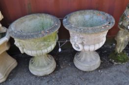 A PAIR OF CONCRETE GARDEN URNS, constructed in two parts, with lion mask handles to a fluted