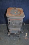 A SHEET STEEL WOOD BURNING STOVE, with rear 5in flue, three doors to front and lid, width 30cm,