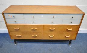 G PLAN, A MID-CENTURY TOLA AND BLACK SIDEBOARD, fitted with six white, over four plain drawers,