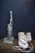 A DYSON DC14 ALL FLOORS UPRIGHT VACUUM CLEANER, and a Morphy Richards ironing station (both PAT pass