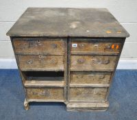 A SCRATCH BUILT 19TH CENTURY PINE BANK OF EIGHT DRAWERS, appears to have been adapted from a pair of