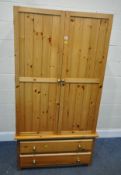 A MODERN PINE DOUBLE DOOR WARDROBE, with two drawers, width 100cm x depth 60cm x height 184cm,
