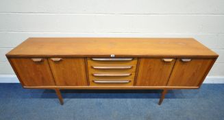 YOUNGER, A MID-CENTURY TEAK SIDEBOARD, fitted with two pairs of cupboard doors, flanking four