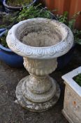 A CONCRETE GARDEN URN, constructed in two parts with a balustered bowl, fluting and acanthus leaf