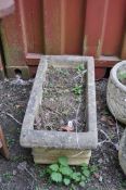 A RECTANGULAR CONCRETE PLANTER, in the form of a decorated sarcophagus, length 67cm