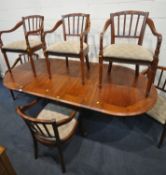 A REPRODUCTION OAK OVAL EXTENDING DINING TABLE, raised on a single pedestal, and four legs, with two