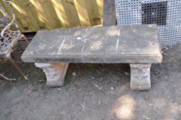 A MODERN CONCRETE GARDEN BENCH, with scrolled and foliate detail to bases, length 122cm