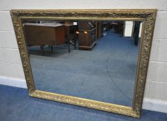 A LARGE RECTANGULAR GILT WOOD FRAME BEVELLED EDGE WALL MIRROR, with scrolled and foliate details,