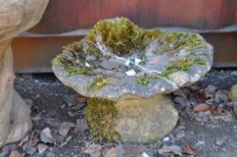 A CONCRETE GARDEN WATER FEATURE in the form of an oyster shell on base with copper pipe