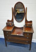 A 20TH CENTURY MAHOGANY DRESSING TABLE, with a bevelled edge oval mirror, six assorted drawers,
