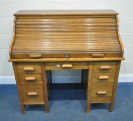 THE LEBUS DESK, AN EARLY 20TH CENTURY OAK DESK, the tambour top enclosing a fitted interior, over