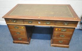 AN EARLY 20TH CENTURY TWIN PEDESTAL DESK, with a distressed green leather writing surface, fitted