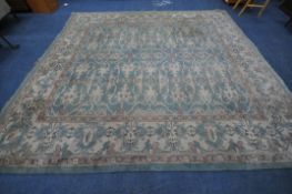 A BLUE GROUND RECTANGULAR RUG, with repeating geometric patterns, surrounded by a multi-strap