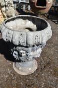 A LEAD ORNATE ITALIAN GARDEN URN, depicting four female masks, and rounded base, diameter 43cm x