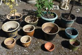 A SELECTION OF GLAZED PLANT POTS, of various sizes and colours, along with three plastic plant