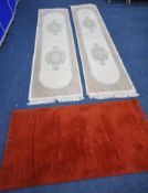 TWO SIZED CREAM GROUND CARPET RUNNERS, with two central medallions, surrounded by a foliate