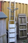 AN ALUMINIUM DOUBLE EXTENSION LADDER AND STAND OFF, with nine rungs to each 270cm section, along