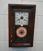 WATERBURY CLOCK CO, AN EARLY 20TH CENTURY MAHOGANY WALL CLOCK, the single door with scrolled and