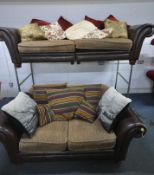 A BROWN LEATHER TWO PIECE LOUNGE SUITE, comprising a large three seater sofa, length 256cm x depth