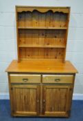 A MODERN PINE SIDEBOARD, fitted with two drawers over double cupboard doors, width 109cm x depth