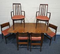 A MID-CENTURY TEAK EXTENDING DINING TABLE, with a single fold out leaf, raised on cylindrical