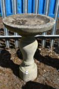 A WEATHERED COMPOSITE BIRD BATH, on a separate bulbous support, diameter 45cm x height 68cm,