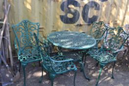 A CAST ALUMINIUM GARDEN TABLE AND FOUR SIMILAR CHAIRS table has pierced fretwork, retailing to