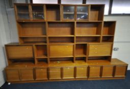 REMPLOY, A MID-CENTURY TEAK MODULAR WALL UNIT, the three bases each with two cupboard doors, and a