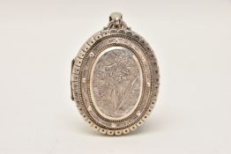 A SILVER LOCKET, a large oval locket with central embossed floral detail, fitted with a large